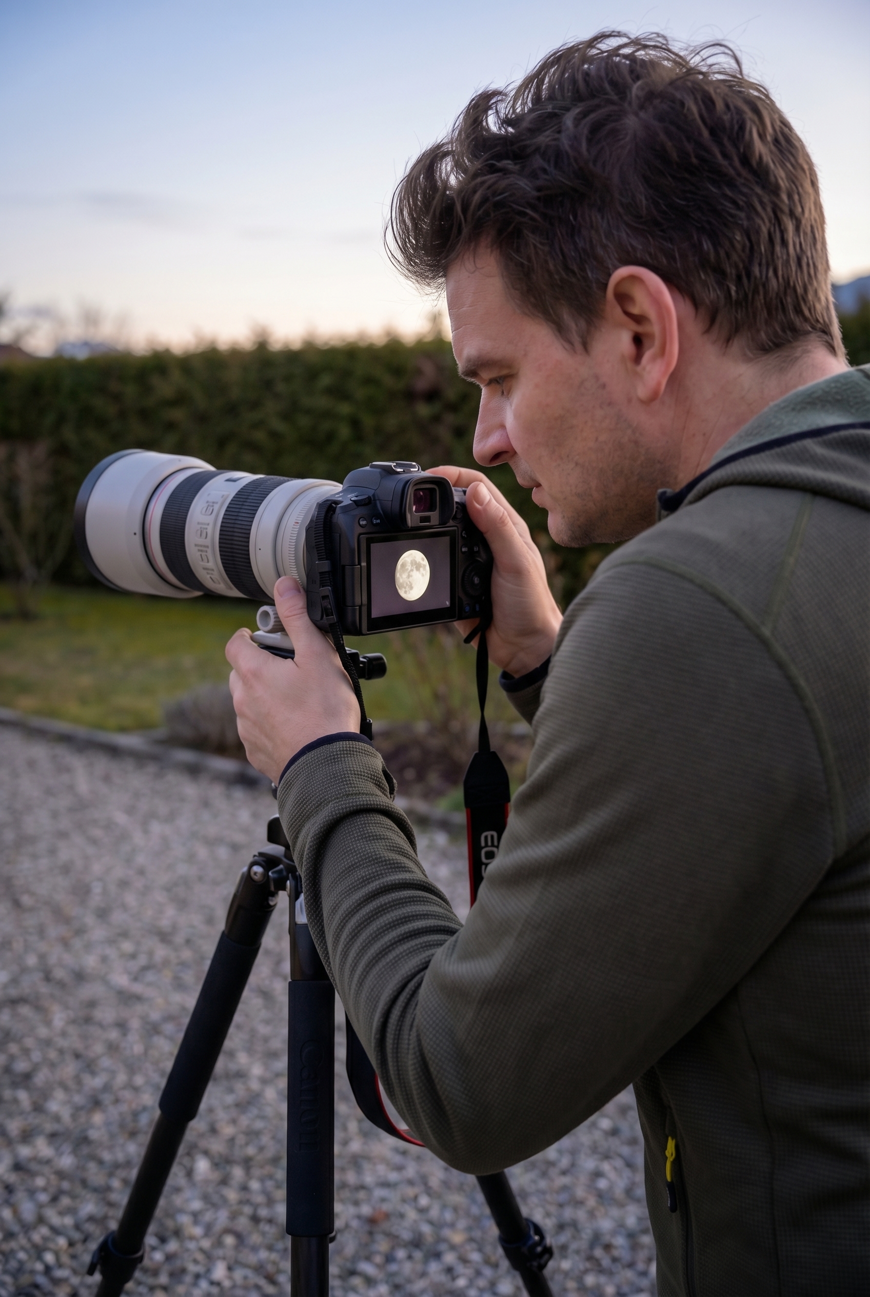 Photographe de nuit utilisant un trépied et un téléobjectif pour apprendre comment photographier la lune et ses cratères.