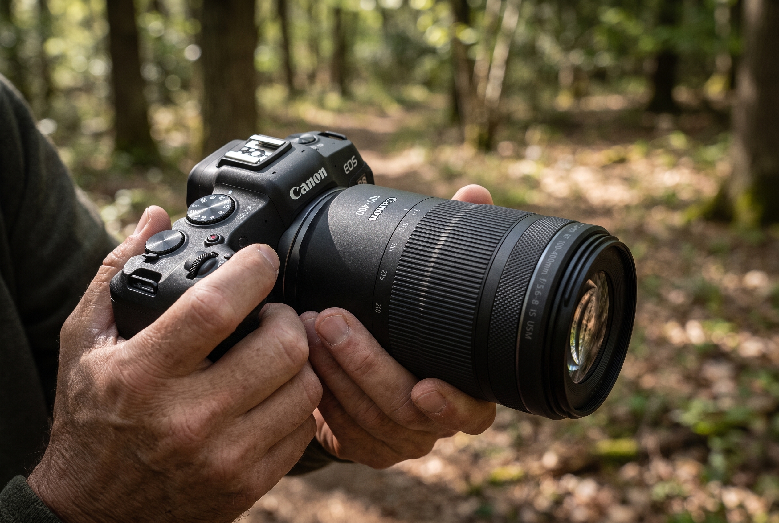 Test Canon R8 : le meilleur hybride entrée de gamme 23 Mains d'un photographe tenant le Canon EOS R8 avec l'objectif RF 100-400mm lors d'un test terrain en forêt pour Pose Nature.